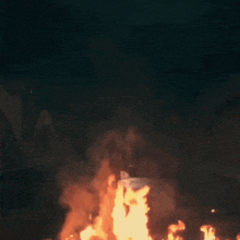 a fire burns in the middle of a dark street at night