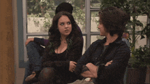 a man and a woman are sitting next to each other and the word oh is visible