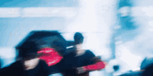 a blurry picture of a person holding an umbrella and a red box that says ' i love you ' on it
