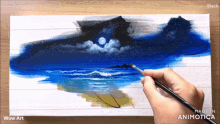 a person is painting a landscape with the words wow art on the bottom right