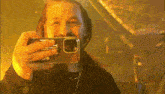 a man is taking a selfie with a phone that says ' ns ' on the back