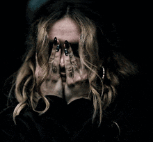 a woman with a surprised look on her face holds her hands to her ears