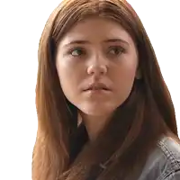 a woman with long red hair is looking at the camera