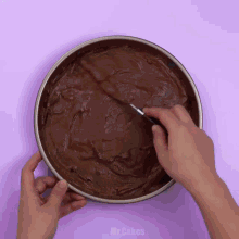 a person is mixing a chocolate cake batter in a pan with a spoon