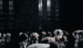 a woman in a white outfit with a cross on her chest is dancing in front of a group of people