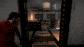 a man in a red jumpsuit is walking through a doorway in a video game