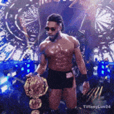 a shirtless wrestler is holding a championship belt with the hashtag tiffanyluv24 on the bottom