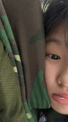 a close up of a girl 's face with her tongue out