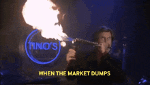 a man is blowing fire in front of a sign for tino 's