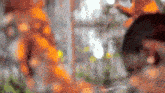 a blurry picture of a person standing in front of a fence