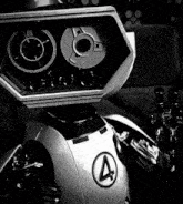 a black and white photo of a robot with the number 4 on its chest