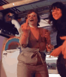 a woman giving the middle finger while holding a glass