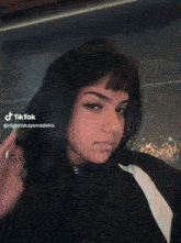 a woman 's face is shown with a tiktok watermark