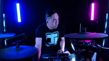 a man playing drums with a shirt that says ec on it