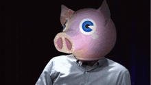 a man wears a pig mask with blue eyes