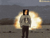 a man with a dog on his sweater is standing in front of an explosion with quickbooks written on the bottom