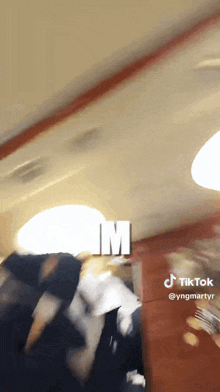 a blurred image of a person with the letter m on the bottom