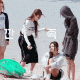 a girl wearing a shirt that says neal sends is sitting on the beach