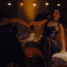 a blurry photo of a woman in a blue dress dancing