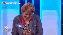 a woman with a name tag that says lucia is smiling