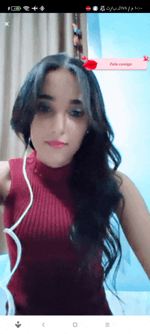 a woman wearing headphones and a red sweater has a red sticker on her head that says " pele contigo "