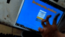 a person is using a computer with drawaria.online written on the screen