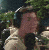 a man wearing headphones talking into a microphone