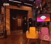 a man stands in front of a tv which says rtl klub