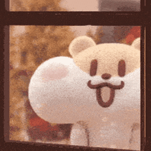 a stuffed animal is looking out of a window with its tongue out