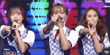 a group of girls singing on a stage with i want asap in the corner