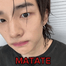 a close up of a person 's face with the word matate written in red