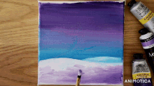 a painting is being painted on a canvas with purple and blue paint