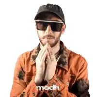 a man wearing sunglasses and a hat has the word mcdh on the bottom