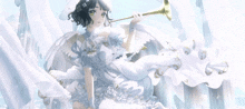 a girl in a white dress with wings is blowing a trumpet