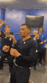 a man is smoking a cigar while dancing in a room with other people .