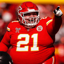 a football player wearing a red jersey with the number 21