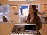 a woman standing in front of a machine that says sorry i 'm late