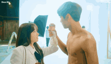 a man without a shirt is being touched by a woman with dear my written on the bottom right