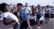 a police officer is talking to a man in a crowd of people