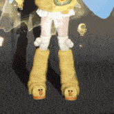a close up of a person 's legs wearing a pair of duck boots .