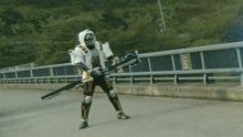 a person in a superhero costume is standing on a bridge with a sword in their hand