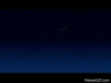 a cartoon of wonder woman with a red star on her head is standing in a dark room .