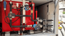 a red box with a bunch of pipes coming out of it