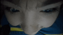 a close up of a person 's face with a shirt that says boy