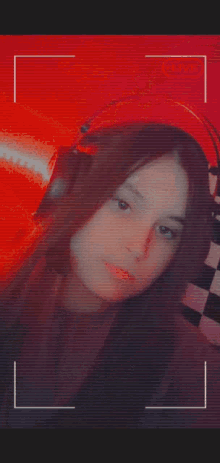 a blurred image of a woman 's face with a red background and a live icon in the corner .