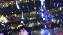 a blurry picture of a woman in front of a building with the word aespa on the bottom right
