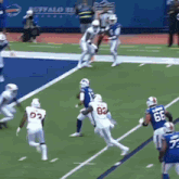 a football game is being played on a field with the buffalo bills logo in the background