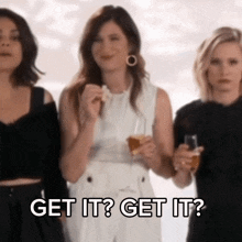 three women are standing next to each other and one of them is saying get it