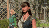 a woman with a necklace that has the letter g on it stands next to another woman