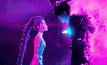 a man and a woman are standing next to each other and looking at each other .